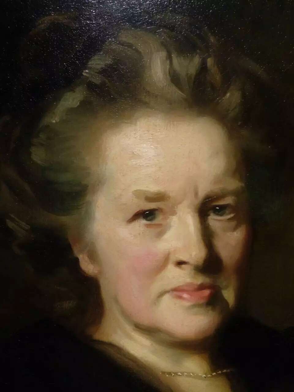A classical female portrait with swept-up hair and warm facial tones.